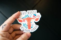 a person holding up a sticker with the words, bed nurse and an orange cow on it