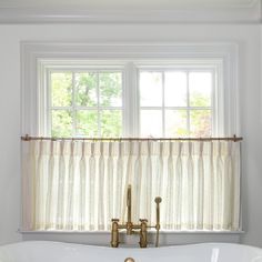 a white bath tub sitting under a window