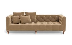 a beige couch with pillows on it and some wooden legs in front of the couch