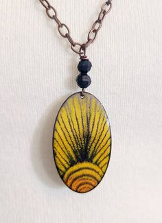 "This pendant is made with black, and yellow enamel torch fired onto a 2\" copper oval shape. I use sgrafitto technique to draw a sun pattern into the enamel before firing. The piece is shown on a chunky 30\" copper chain. You can attach lobster clasp anywhere on the chain to adjust length. Please remember - these pieces are custom made, which means the finished product may vary slightly from the photo." Handmade Black Enamel Necklace, Draw A Sun, Torch Fired Enamel Jewelry, Enameling Jewelry, Terracotta Jewellery Making, Enamel Stud Earrings, Butterfly Wing Earrings, Terracotta Jewellery, Sun Necklace