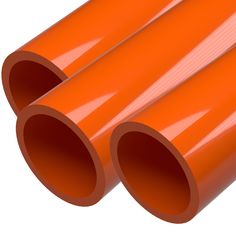 three orange pipes are stacked on top of each other, with the ends pointing upward