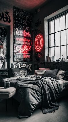 a bed sitting under a window next to a neon sign