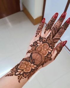 a woman's hand with henna tattoos on it