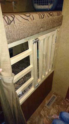 the inside of a camper with its door open and curtains pulled up to allow privacy