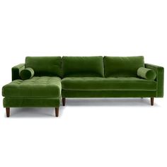 a green couch and footstool sitting next to each other on a white background