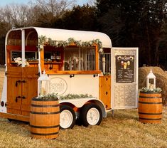 an old fashioned food truck is decorated with greenery