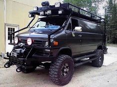 an off road vehicle parked in front of a building