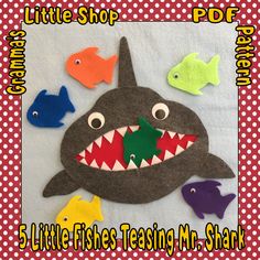 an image of a shark with fish on it's back and the words, little shop