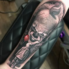 a man with a clown tattoo on his arm