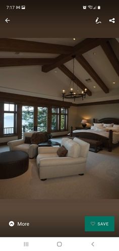 a living room filled with furniture next to a large window covered in wood beams