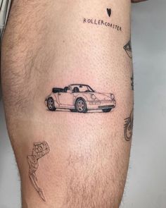 a man with a tattoo on his leg that has a sports car drawn on it