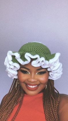 a woman with braids wearing a crochet hat