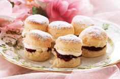 small pastries on a plate with pink flowers in the background