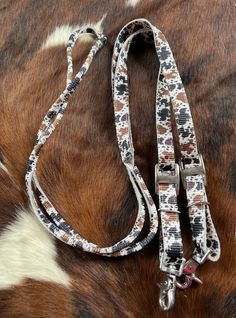 an animal print leash on top of a cowhide