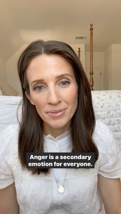 a woman with long brown hair is looking at the camera and has an ad on her face that says anger is a secondary emotion for everyone