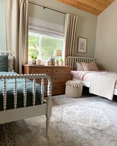 a bedroom with two twin beds and a rug on the floor