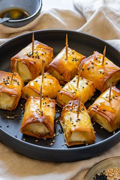 some food is sitting on a plate with toothpicks in it