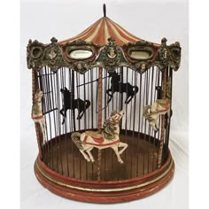 an old fashioned carousel with horses in the center and mirrors on top, sitting on a white background