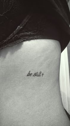 a woman's stomach with the word be still written on it, in black and white