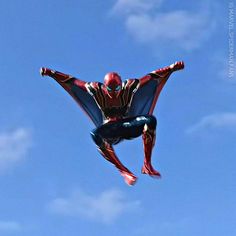 a spider man is flying through the air