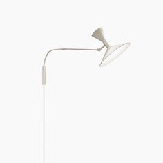 a white floor lamp sitting on top of a table