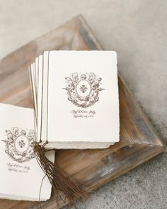 three wedding cards on a wooden tray