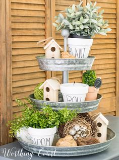 three tiered tray with plants and bird houses