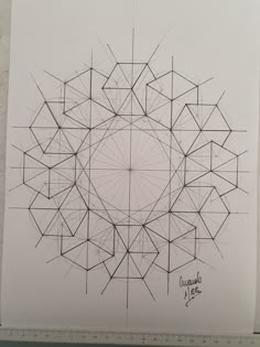 a drawing on paper with lines and circles in the center, all drawn by hand