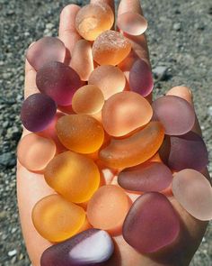 a hand is holding some glass pebbles in it's palm, with the caption explore