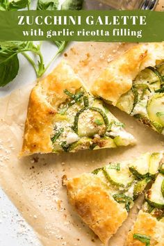 zucchini galette with garlic and ricotta filling on a cutting board next to a glass of water