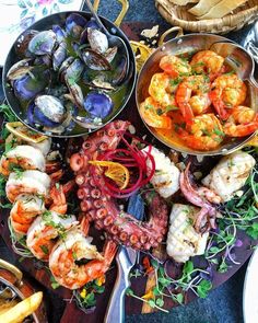 an assortment of seafood is displayed on a platter