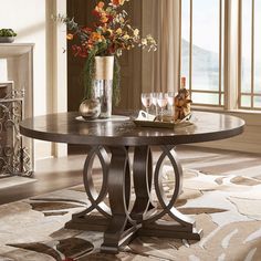 a table that has some flowers on it in front of a fire place and windows