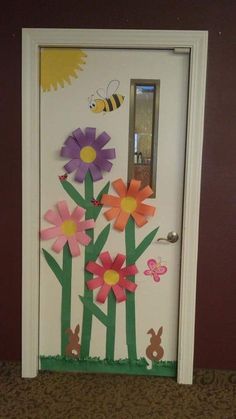 the door is decorated with paper flowers and a bee on it's back side