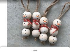 small snowmen are tied to twine and placed on the concrete floor with red string