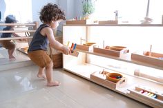 a small child playing with toys in a room