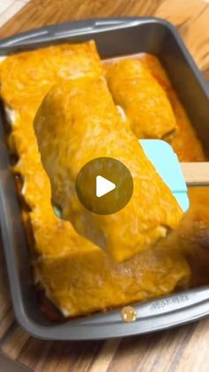 a pan filled with food on top of a wooden table