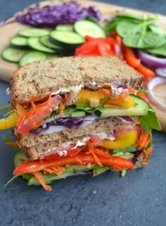 a cut in half sandwich sitting on top of a cutting board