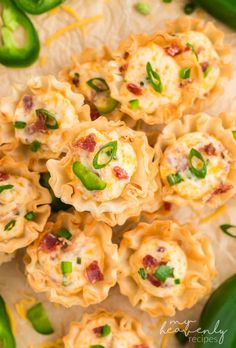 some food that is sitting on top of a table with peppers and green peppers around it