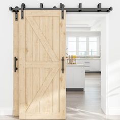 an open sliding door in a white room with hardwood floors and cabinets on either side