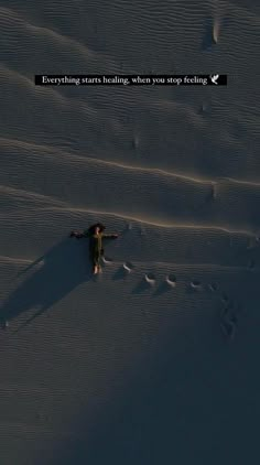 a person standing in the snow with their arms spread out and there is a quote above them