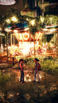 two people standing in front of a carousel at night