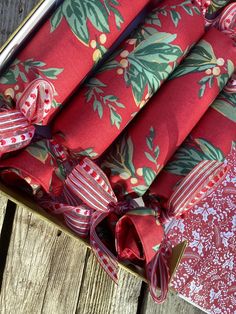 an open gift box with red wrapping and ribbon