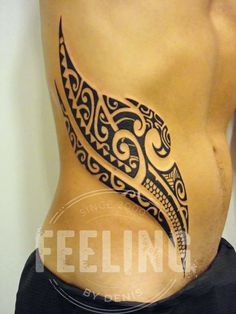 a man's stomach with an intricate tattoo design on his belly and back side