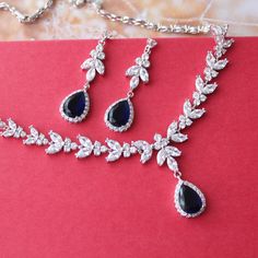 a necklace and earring set on a red background