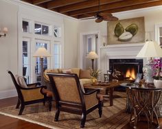 a living room filled with furniture and a fire place under a painting on the wall