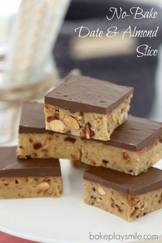 four pieces of chocolate peanut butter bars stacked on top of each other with almonds