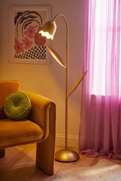 a living room scene with focus on the floor lamp and chair next to the window