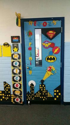 a door decorated to look like batman and the words heros are on display in front of it