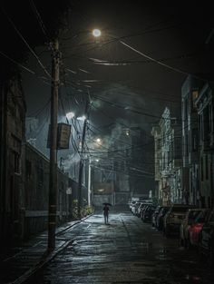 a person walking down a dark street at night