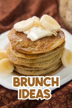 a stack of pancakes topped with bananas and butter on top of a brown table cloth